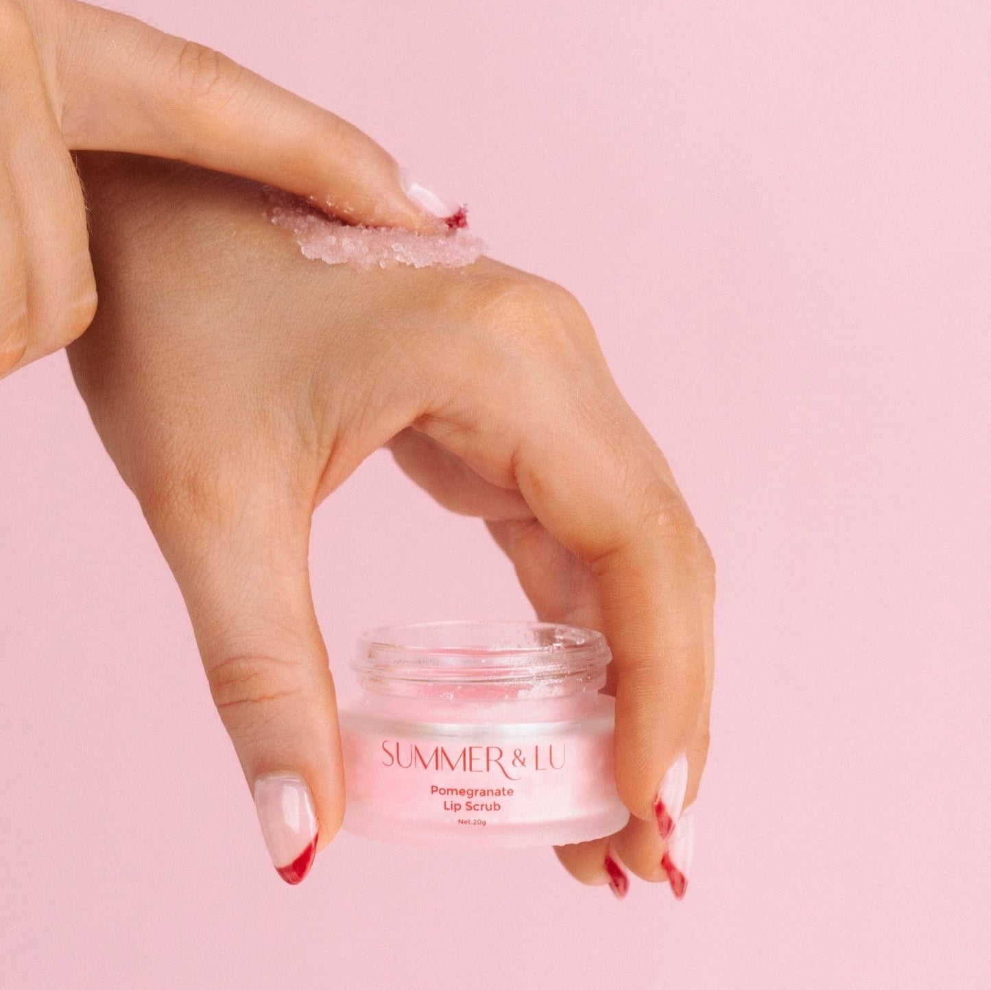 Gently exfoliating lips with sugar-based watermelon or pomegranate lip scrub