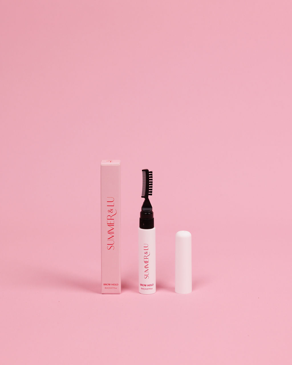 Applying Brow Hold Gel with comb side for a natural, fluffy brow finish