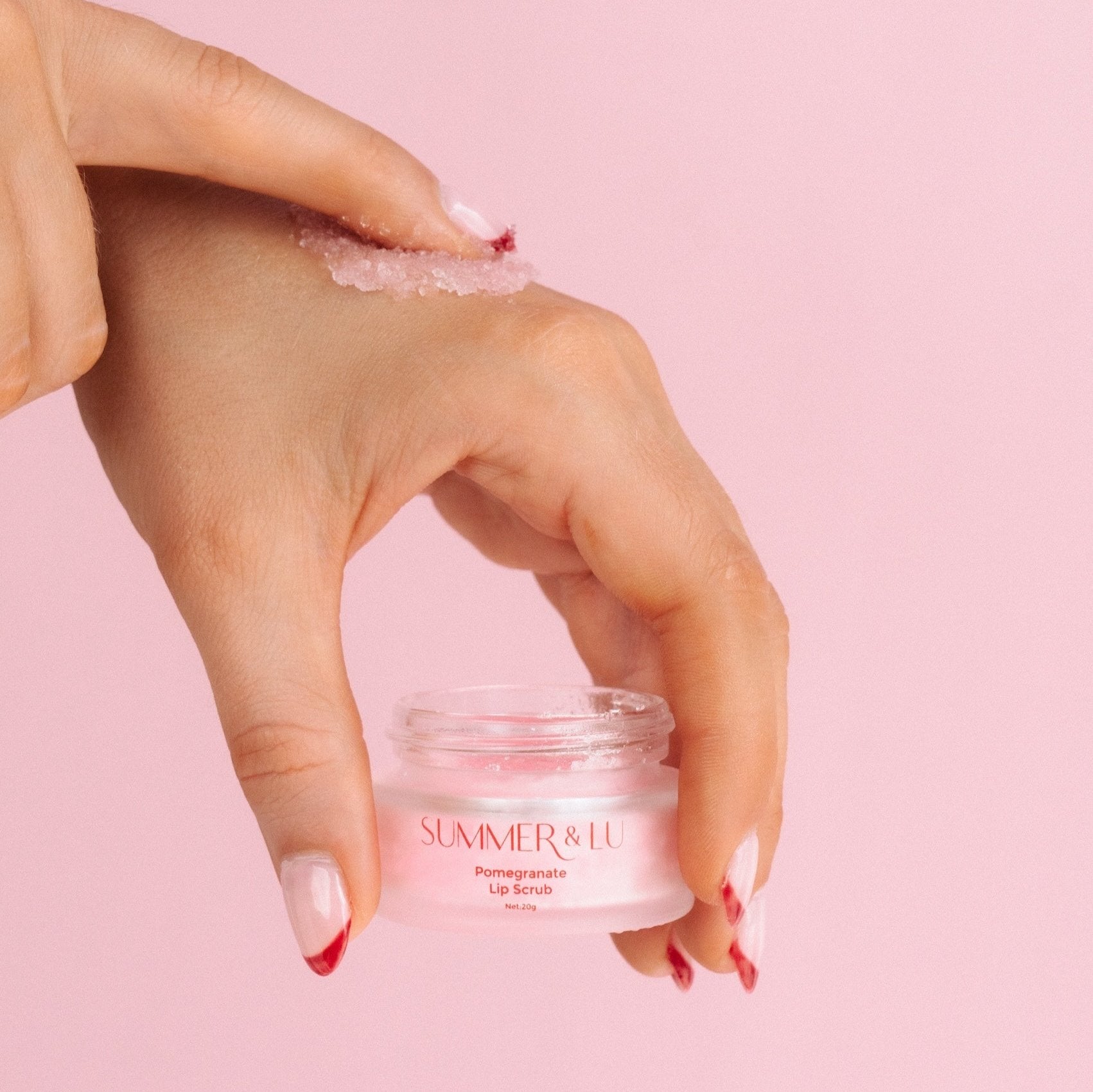 Gently exfoliating lips with sugar-based watermelon or pomegranate lip scrub